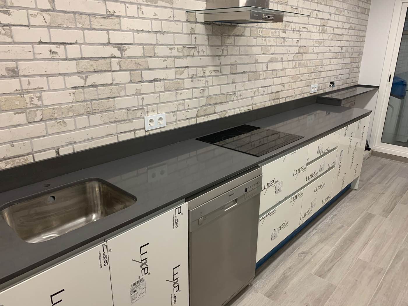 Cocina reformada por Grupo Diper con espacios conectados y acabados contemporáneos